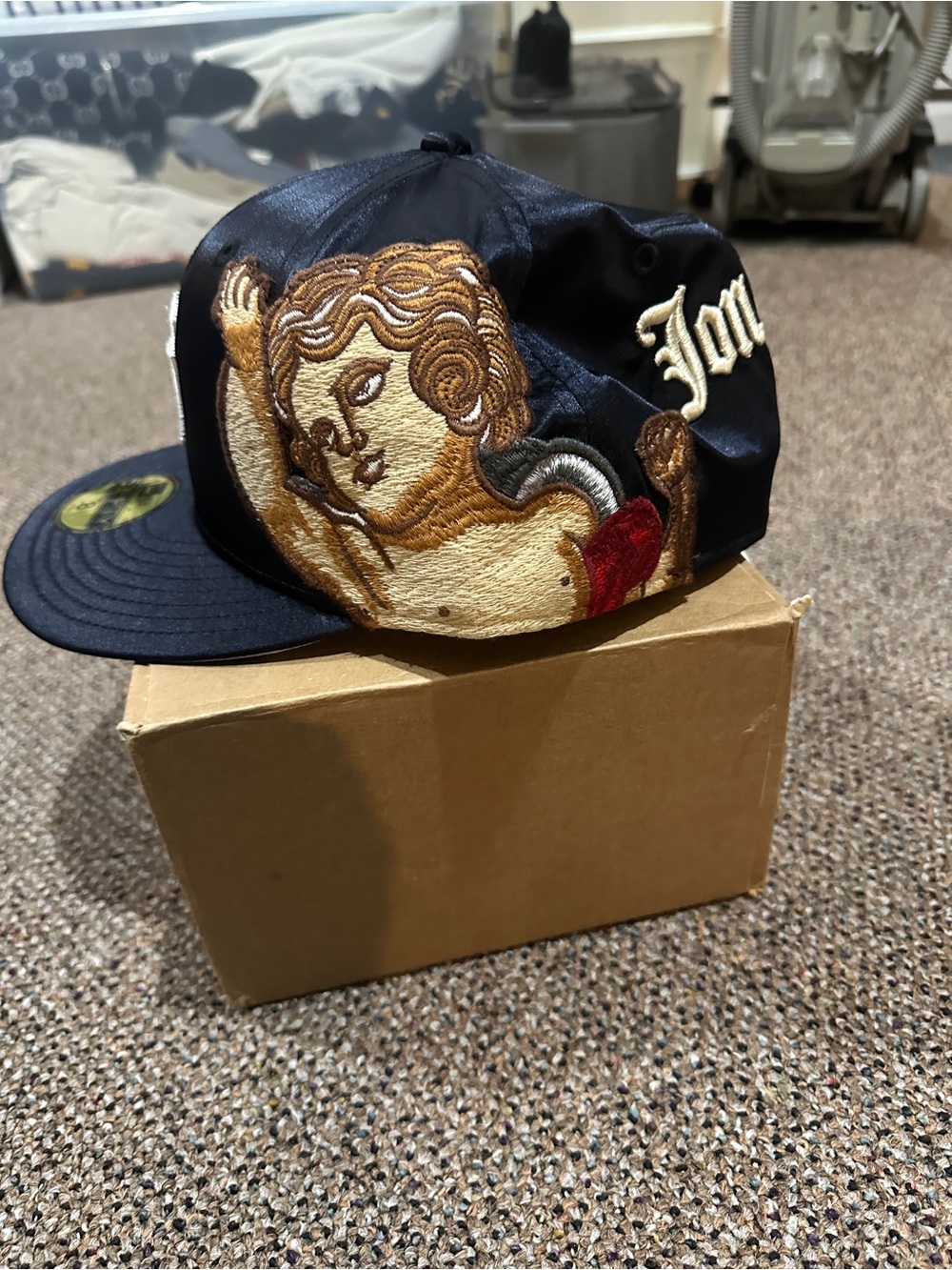 Black Embroidered Cherub Snapback Hat with Gold and Red Accents